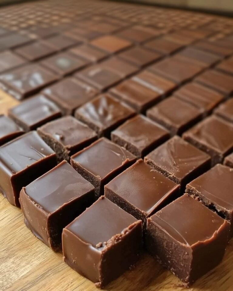 Squares of homemade 3 Minute Fudge with sprinkles and nuts on top.