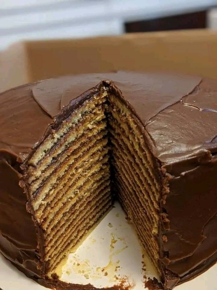 A tall 15-layer old-fashioned chocolate cake with rich chocolate frosting between every layer.